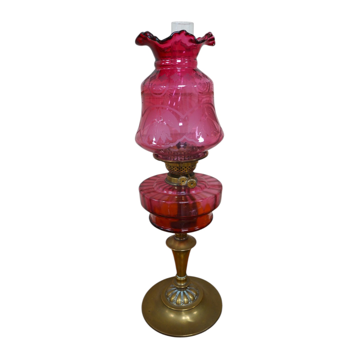 A Victorian oil lamp on brass base with cranberry font, acid etched cranberry shade chimney, overall 62cm high. Condition - good